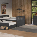 gray full size captains bed with open twin trundle and open drawer in nursery with 6 drawer dresser