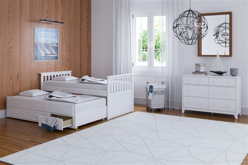 White twin size captains bed with open twin trundle and open drawer in nursery with 6 drawer chest