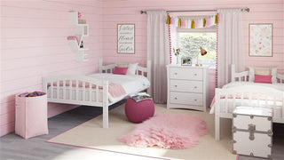 white bunk bed configured as two separate twin beds in nursery with 3 drawer chest