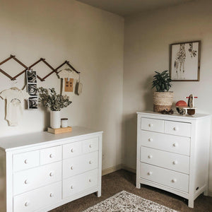 White 6 drawer dresser and white 4 drawer chest in nursery