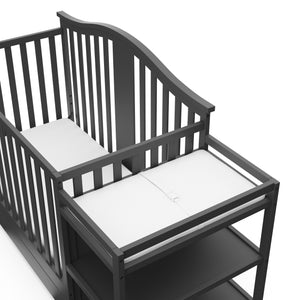 Close-up view of gray crib and changer