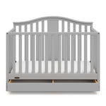 Pebble gray crib with open drawer angled