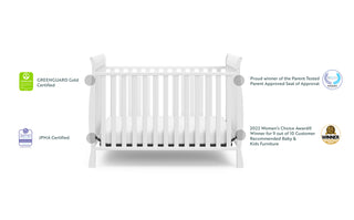 White crib angled with awards and certificates graphic