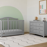 Pebble gray crib with drawer in nursery