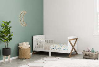 white and vintage driftwood toddler bed in nursery