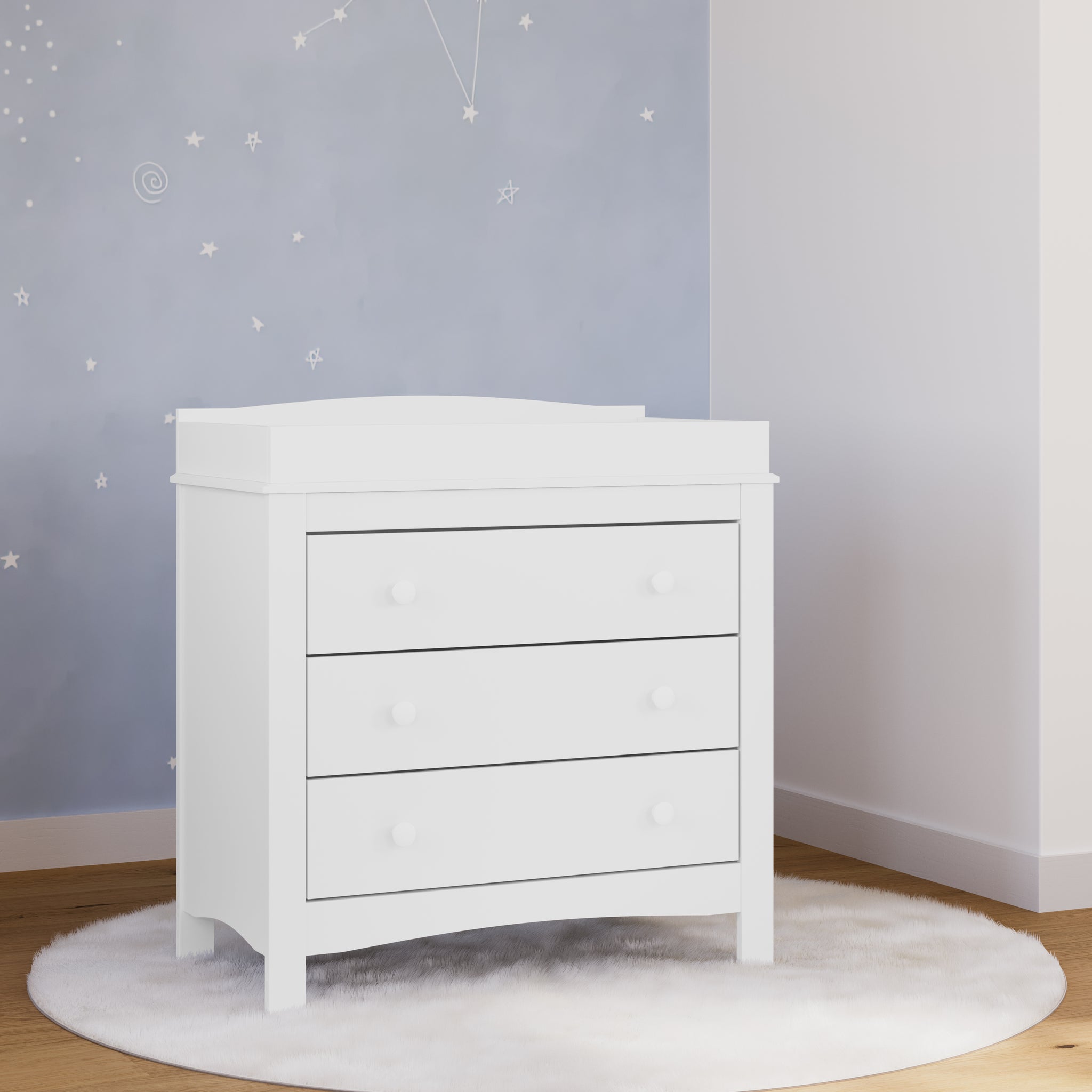 white 3 drawer dresser with changing topper in nursery