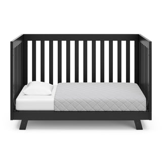 Black crib in toddler bed conversion