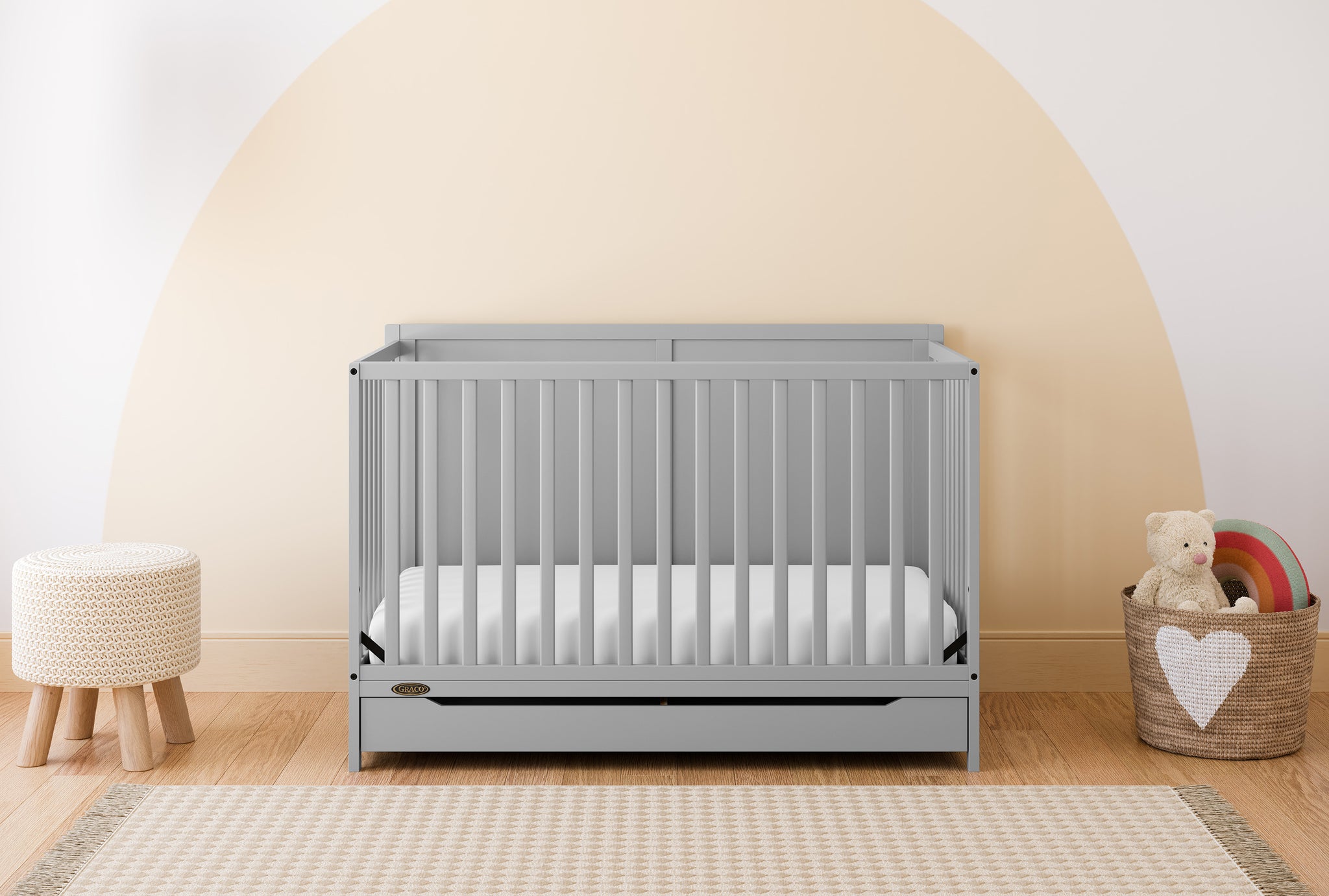 pebble gray crib with drawer in nursery