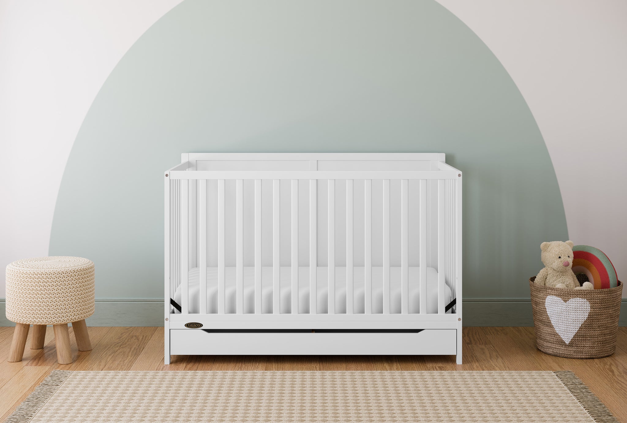 white crib with drawer in nursery