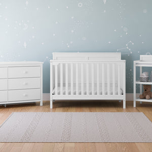 white crib, 6 drawer dresser, and changing table in nursery