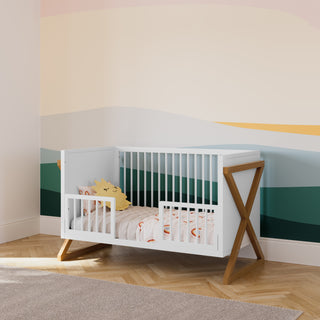 white toddler safety guardrail with dowels applied in toddler bed, in nursery