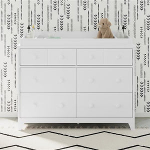 white changing topper on top of 6 drawer dresser in nursery  