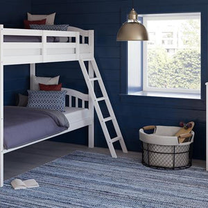 white bunk bed with fixed ladder angled in nursery with 4 drawer chest