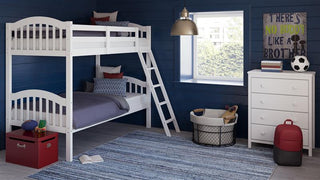 white bunk bed with fixed ladder angled in nursery with 4 drawer chest