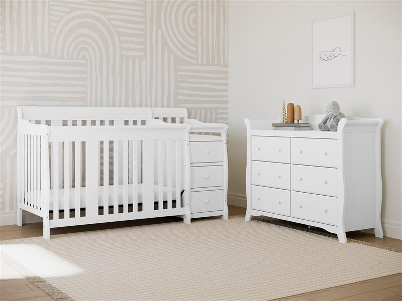White crib and changer in nursery 
