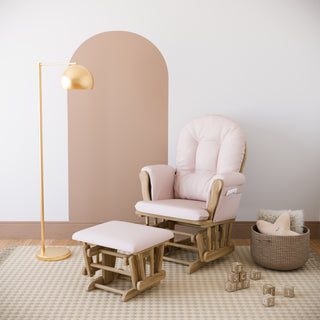 natural glider and ottoman with pink cushions in nursery
