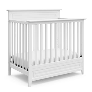 White mini crib angled 