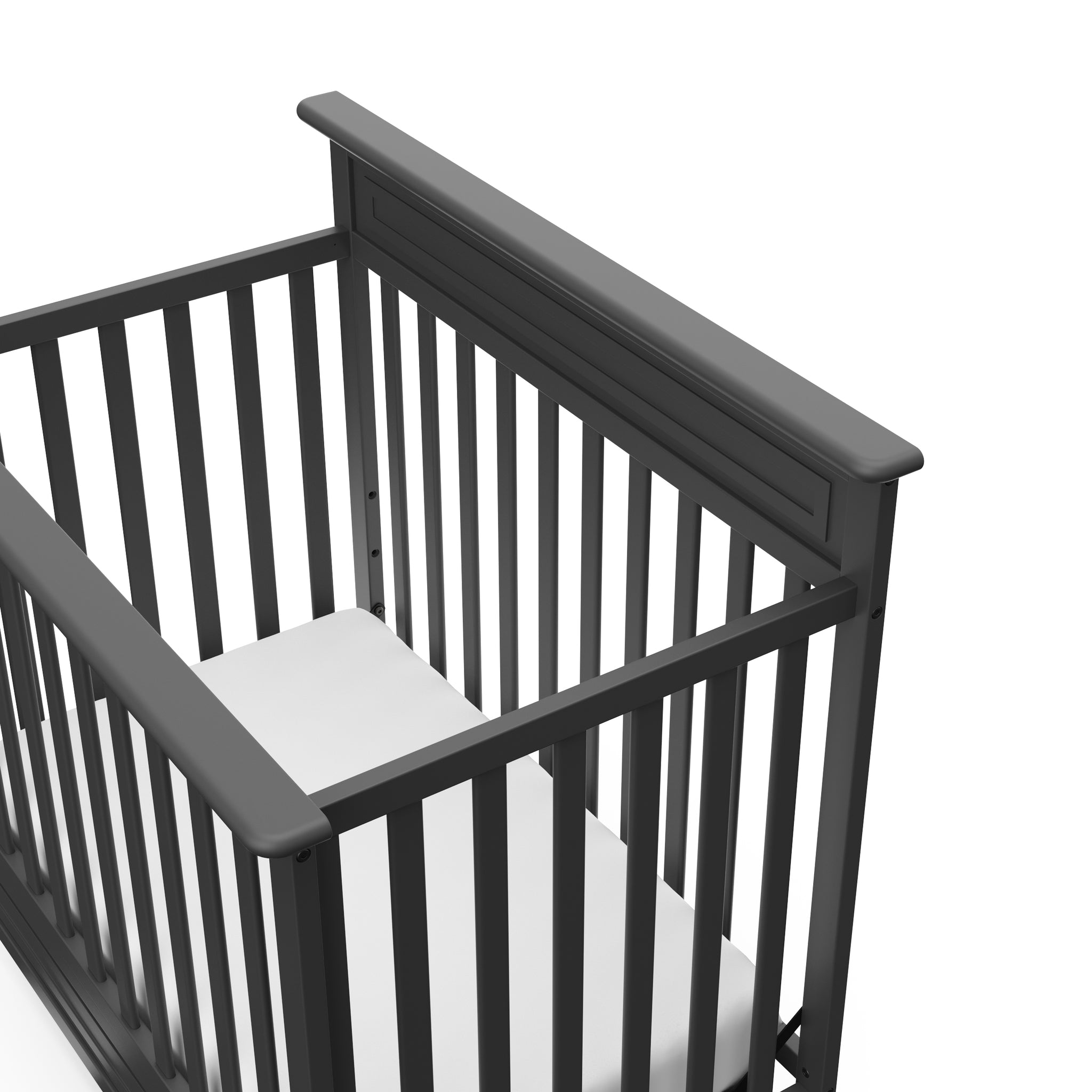 Close-up view of gray mini crib's headboard 