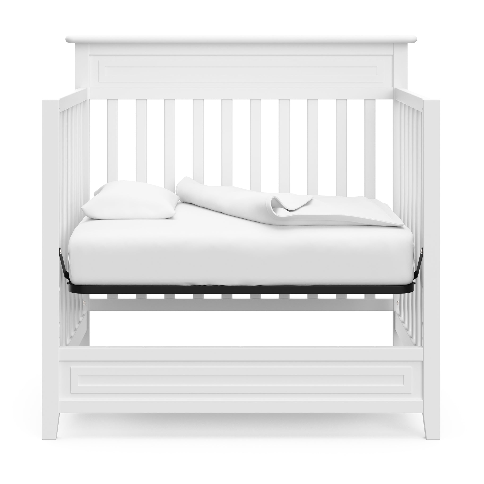 White mini crib in daybed conversion 