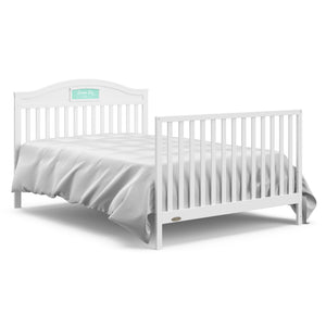 White crib with drawer in full-size bed with headboard and footboard conversion