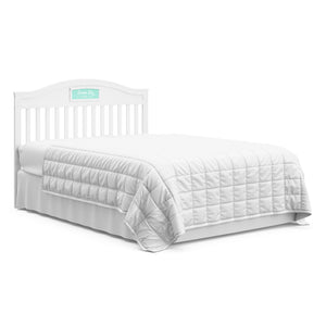 White crib with drawer in full-size bed with headboard conversion