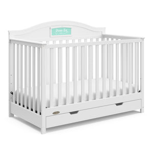White crib with drawer angled