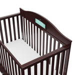 Close-up view of espresso crib with drawer