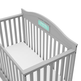 Close-up view of Pebble gray crib with drawer