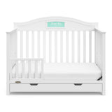 White crib with drawer in toddler bed conversion with one safety guardrail