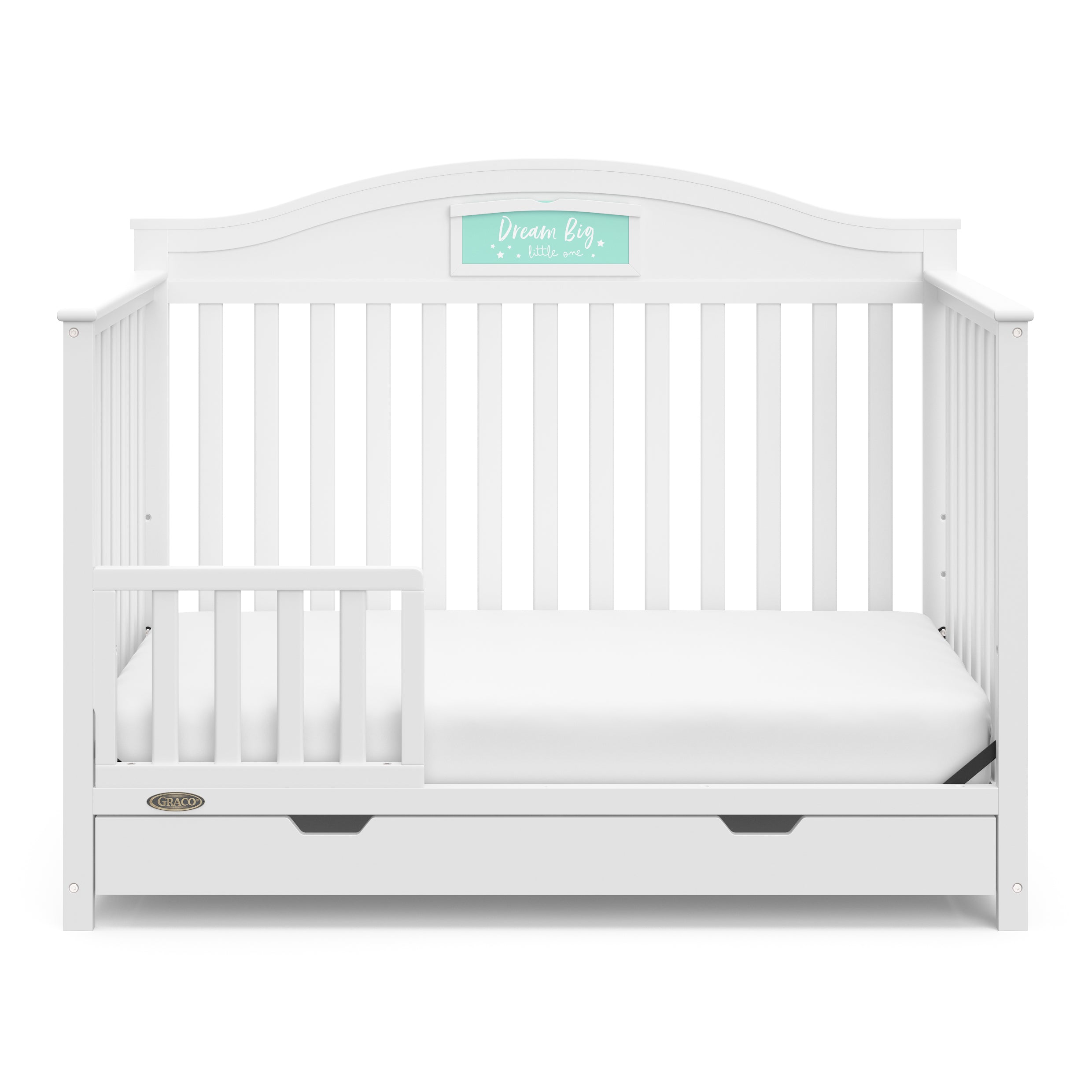 White crib with drawer in toddler bed conversion with one safety guardrail